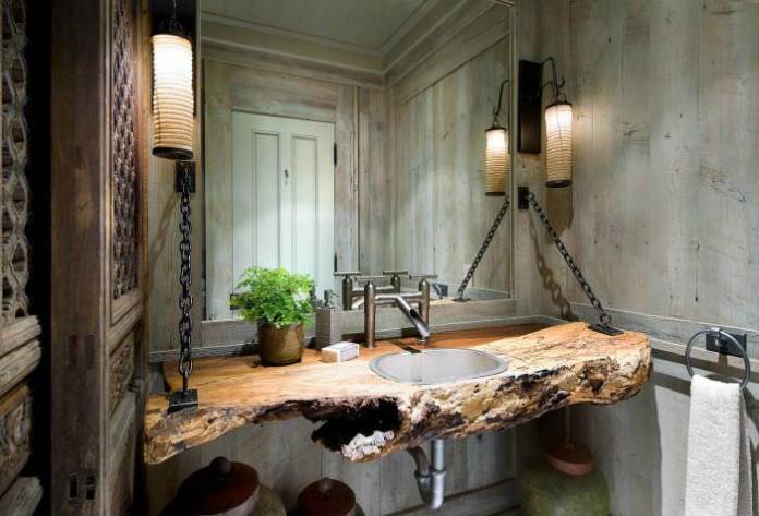 bancada feita em madeira com peças de metais para decoração de um banheiro rústico