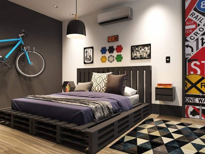 quarto juvenil com o uso de um preto e branco trazendo um charme especial e para completar enfeites como uma bicicleta sobre a parede, um tapete geométrico.