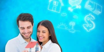attractive young couple holding model house against blue background with vignette