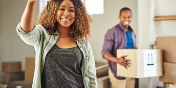 brand new starti got keys house portrait cheerful young woman holding keys her house with her partner back carrying boxes