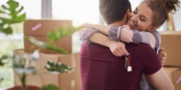 happy couple with keys new apartment