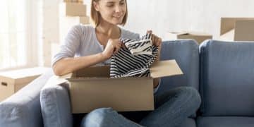 woman packing box with clothes move house